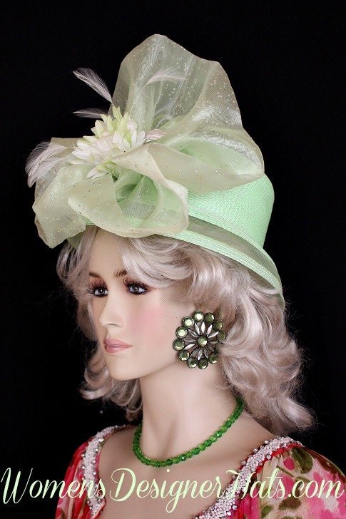Ladies Lime Designer Fashion Hat For Special Occasions, The Kentucky Derby Horse Races. This Haute Couture Headpiece Hat Is Trimmed With A Sheer Pastel Lime Green Organza Bow With Silver Accents, Adorned With A Custom Made Delicate White Celery Lime Silk Millinery Flower. Delicate White Feathers Are Placed Within The Flowers. A Beautiful Dress Hat For A Bride, Wedding Guest Or Church.