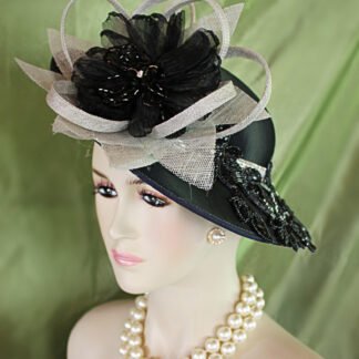 Women's Haute Couture Black Satin Grey Sinamay And Metallic Silver Formal Designer Shallow Brim Hat. This fashion hat is embellished with a large handmade silver gray sinamay straw loop flower petal bow. Placed within this elaborate bow is a black handmade organza bow enhanced with wired glass beaded flower petals adorned with a glass rhinestone. Glamorous black sequin glass beaded rhinestone floral appliques are placed around the hat. A very expensive glass rhinestone trim encircles the crown of this high fashion hat. You will definitely be noticed wearing this statement designer hat.