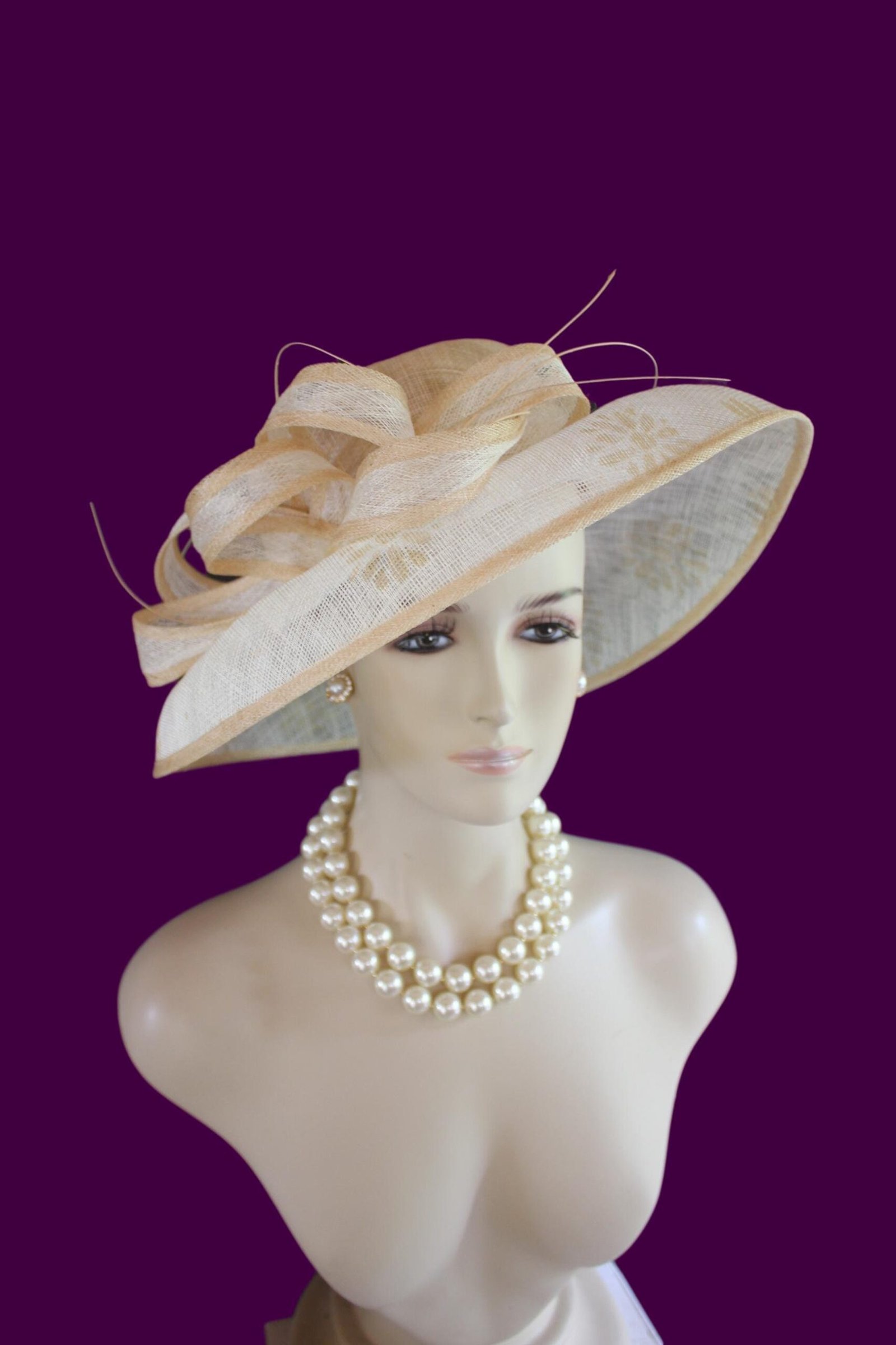 Women's Formal Haute Couture Big Brim Natural White And Beige Ivory Sinamay Straw Fashion Hat. This Decorative Wide Printed Brim Kentucky Derby Hat Is Embellished With A Large Bow And Embellishments. Feminine And Romantic.