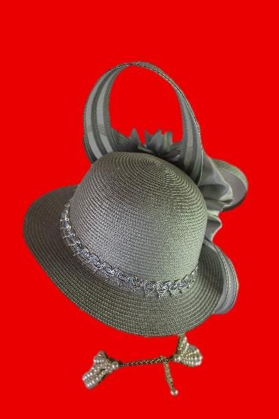 Haute Couture Designer Avant Garde Shaped Sculptured High Fashion Hat For Women. This Formal Wedding Hat Is Embellished With A Large Gray Satin Hand Made Bow Enhanced With A Combination Of Gray Poly Straw Sculptured Loop Bowing. Placed With This Beautiful Bow Is Are Large Handmade Vintage Gray Satin Flowers Embedded With Vintage Silk Millinery Flower Centers. A Beautiful Embroidered Sequin Trim Encircles The Lower Crown Of This Beautiful Headpiece Cocktail Hat. This Avant Garde Hat Is A Fashion Statement Piece.This Formal Hat Can Be Worn In Different Positions. The Bowing Can Be Worn Toward The Face Or Toward The Back Of The Head.